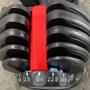 Strength Training Equipment- (300*300)- Adjustable dumbbell with view of one side of the weight plate area with dial visible