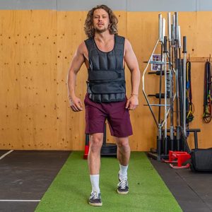 Gym Accessories- (300*300)- Front view of a Man wearing the Weight vest shown walking towards the camera