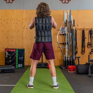 Gym Accessories- (300*300)- Rear view of a Man wearing the Weight Vest in a gym setting