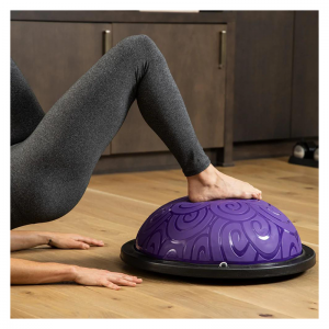 Strength Training Equipment- (300*300)- Cropped view of a woman with legs and hands visible performing hip raises using the Purple Bosu Ball