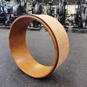 Yoga Product- (300*300)- Side view of the Cork Yoga Wheel in vertical position shown in gym setting