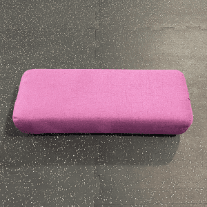 Yoga Product-(300*300)- Pink coloured Rectangular Bolster on gym floor