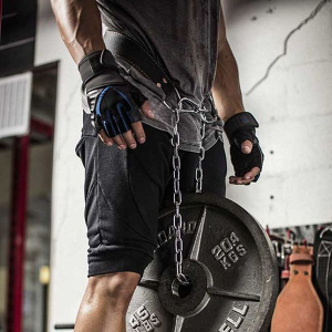 Weight Lifting Gear- Torso view of a man equipped with weight lifting belt with chain and 20.4KG black weight plate attached