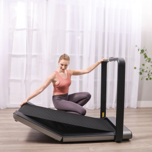Cardio Equipment- Woman folding the WalkingPad x21 Double-Fold treadmill into the active position