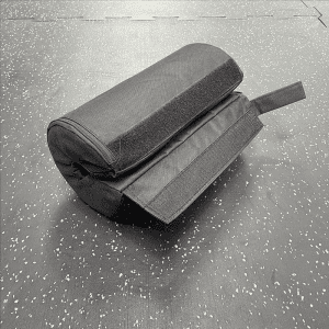 Strength Training Equipment- Black Barbel Pad on the floor with velcro strap visible
