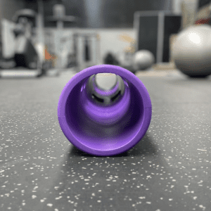 Gym Equipment- (300*300)- Side view of the 4KG Purple Colour VIPR Natural Rubber Weight Fitness Barrel on gym floor