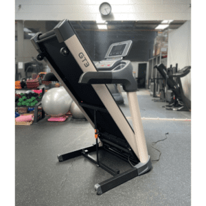 Cardio Equipment- (300*300) image- Rear Profile View of the Light Commercial Motorized Treadmill DB-2006 in folded position in a gym setting
