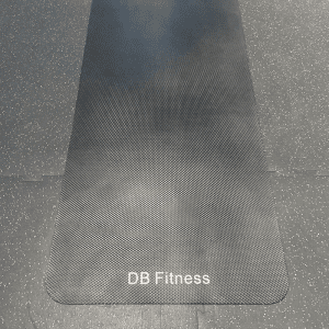 Gym Accessories- Low resolution- 300*300 image of 1.5M X 0.7M Black equipment mat with "DB Fitness" text imprinted on the lower side placed vertically on gym floor