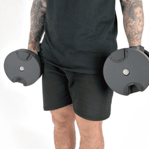 Man carrying an adjustable 32kg dumbbell