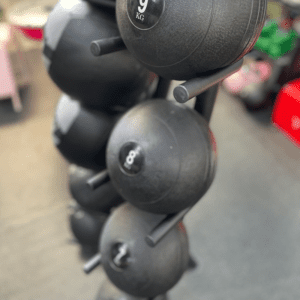 Closeup look of medicine ball stand with balls in gym