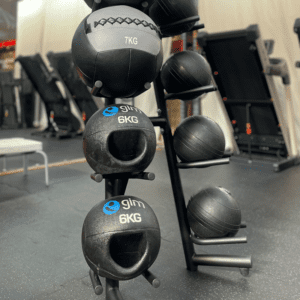 Side view of medicine ball stand with balls in gym