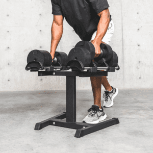 A man placing dumbbell to dumbbell rack