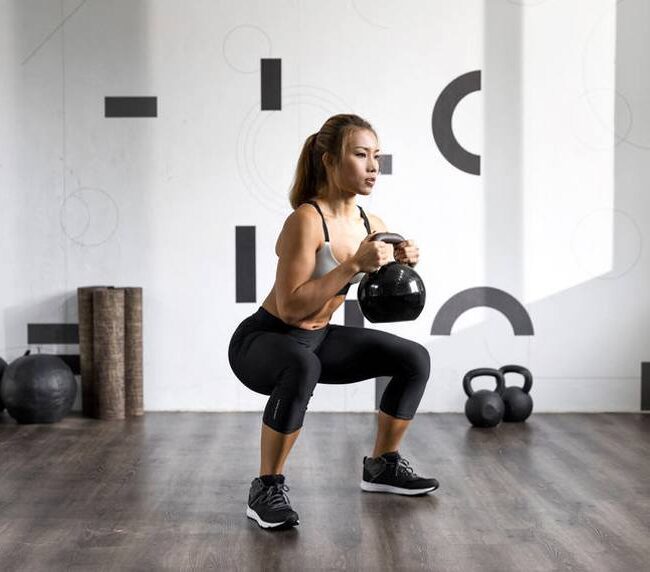 Intess woman squat kettlebell functional fitness