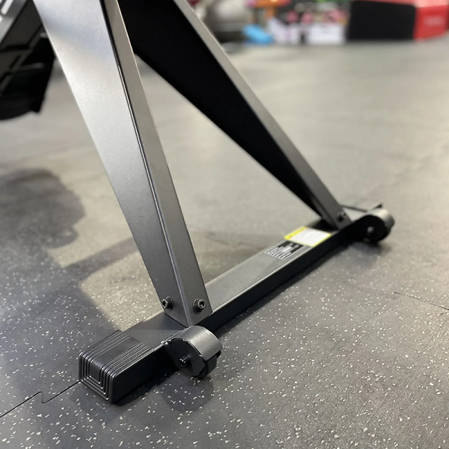 DB Fitness air rower front stabiliser base and frame detail on gym flooring